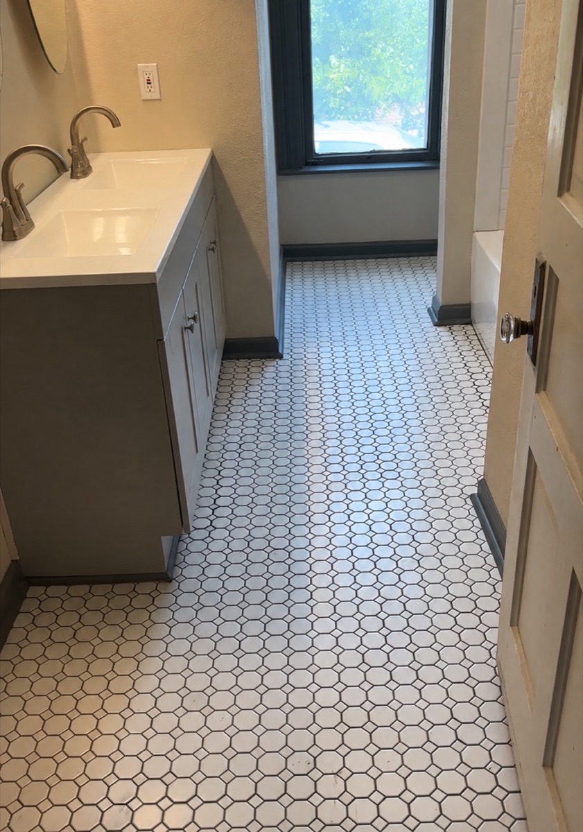 Renovated bathroom with new double vanity and hex tile floor